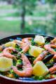Close up classic seafood paella with mussels, shrimps and vegetables in frying pan