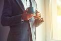 businessman hand holding morning tea or coffee