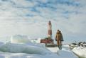 Winter Lighthouse. fisherman on The Lighthouse island in the winter on the Ladoga Lake. Suho Island. Russia.