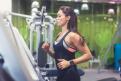 Fit woman exercising on treadmill in gym.