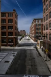 Boston, MA, US 25 Jul. 2009: Old Residential Buildings in bay area in front of cloudy sky with trace of jet airplane