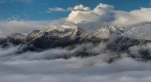 Snow mountain tops in clouds. Dawn. Mount Mamkhurts. Caucasus mountains.