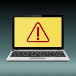 Laptop with exclamation mark on the display