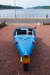 Oban, United Kingdom - February 20, 2010: blackjack avion car on parking at sea quay. Blue automobile with three wheels. Kit car on gravel ground. Transport and transportation. Travel and wanderlust