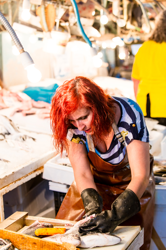 young woman cutting the fish