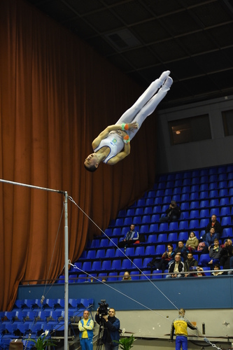 Male gymnast performing during competition